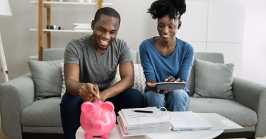 Couple saving with a piggy bank